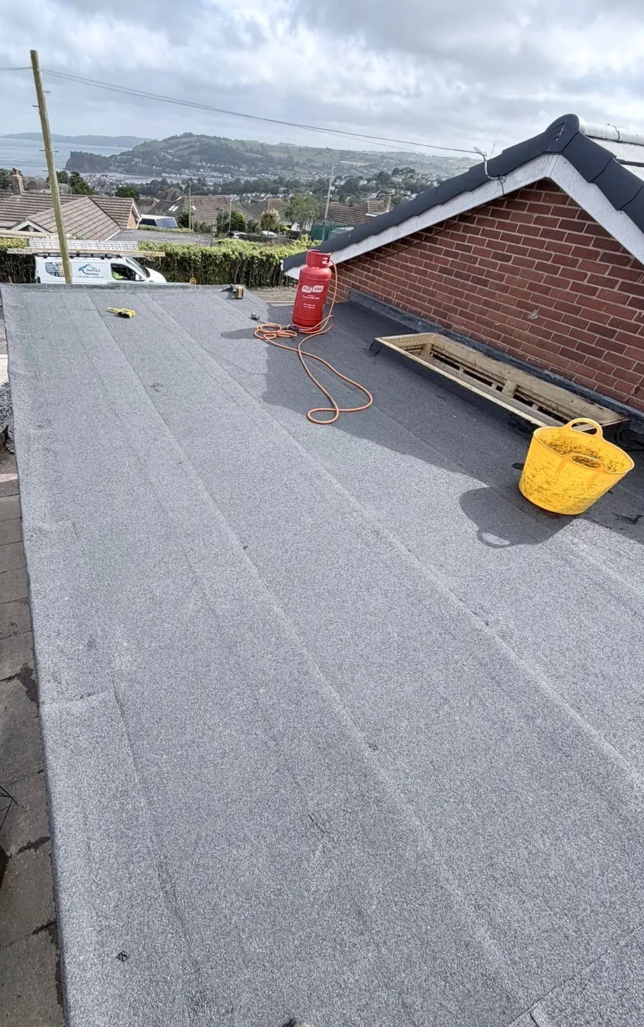 New felt flat roof being installed on an extension