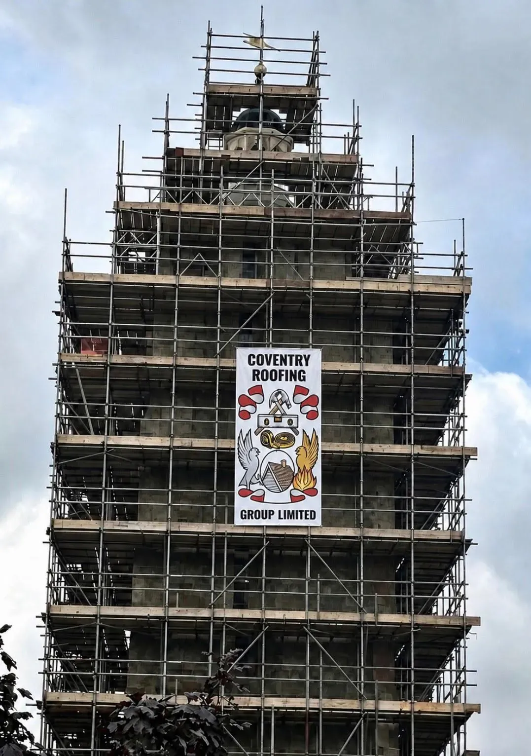 Coventry Roofing Group banner on a scaffolded heritage tower restoration project